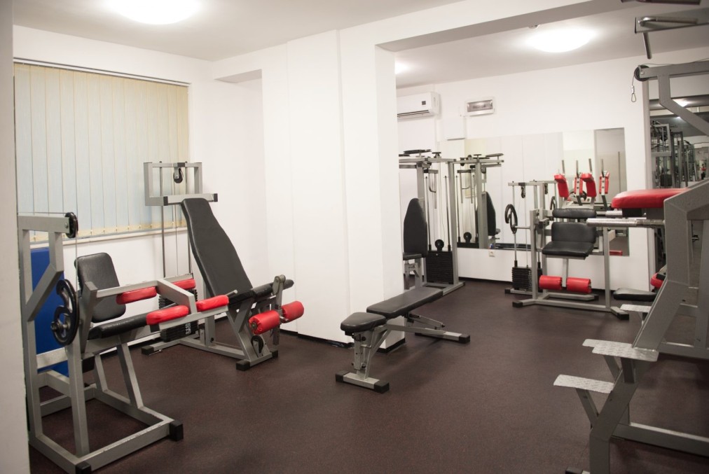 Compact gym room with benches and resistance machines for focused workout sessions