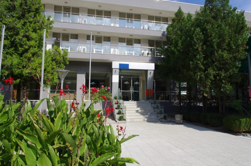 Hotel entrance with landscaped walkway and balconies, accommodation for training camp teams