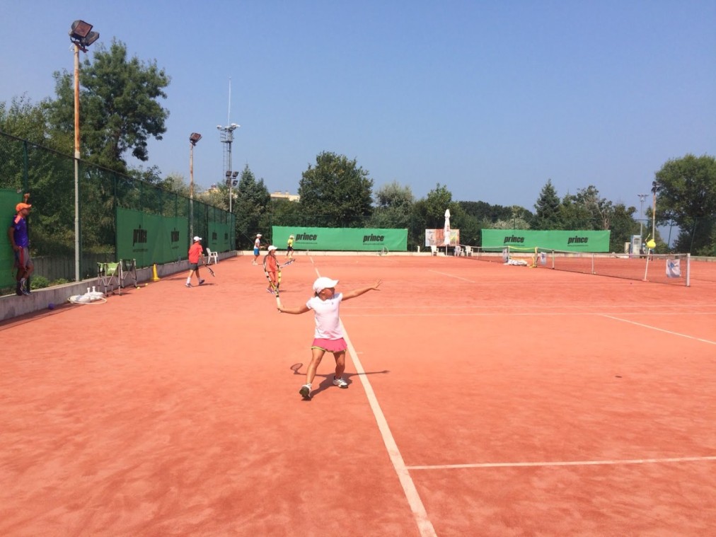 Outdoor clay tennis court in use
