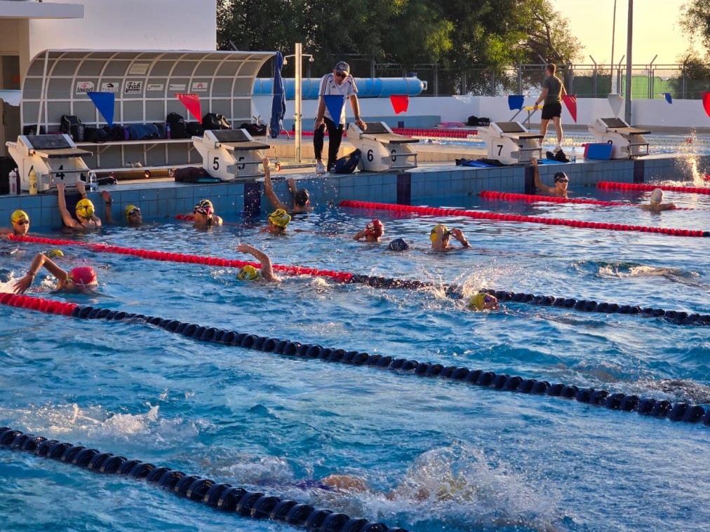 Training session in progress — swimmers across all lanes
