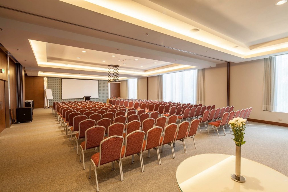 Conference room in theatre layout with screen and podium