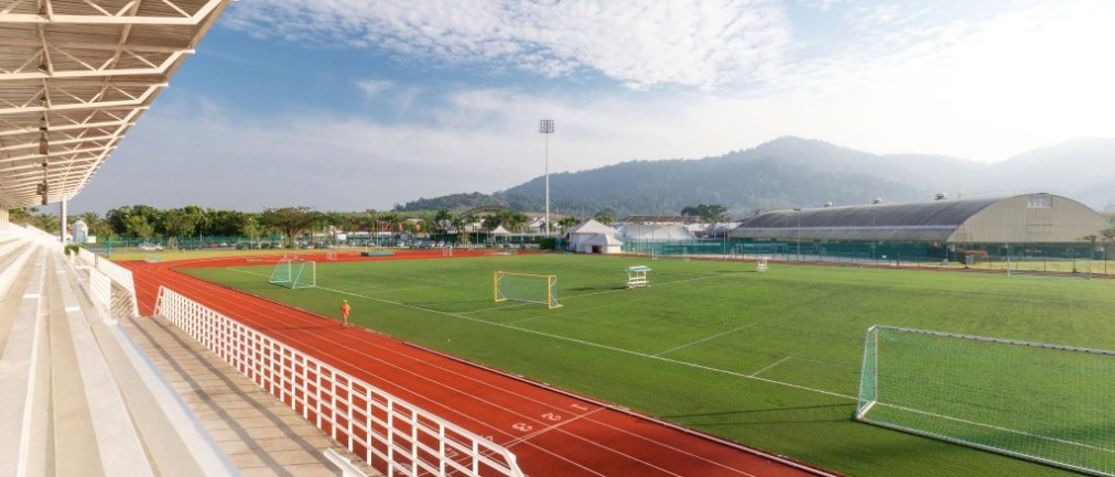 Football pitch with running track and grandstand seating