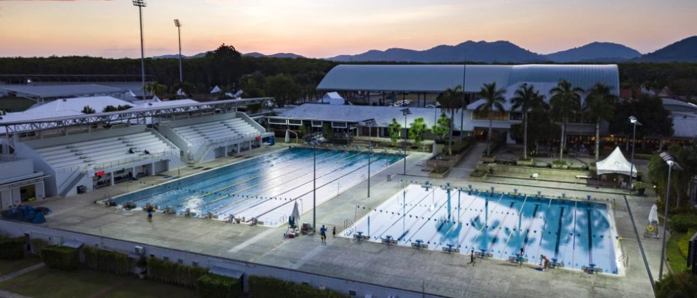 Aquatics complex with two outdoor pools, dusk