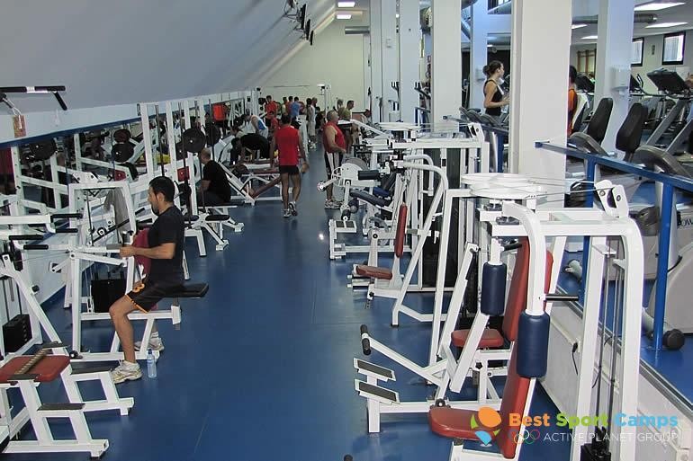 Strength training room with weight machines and benches