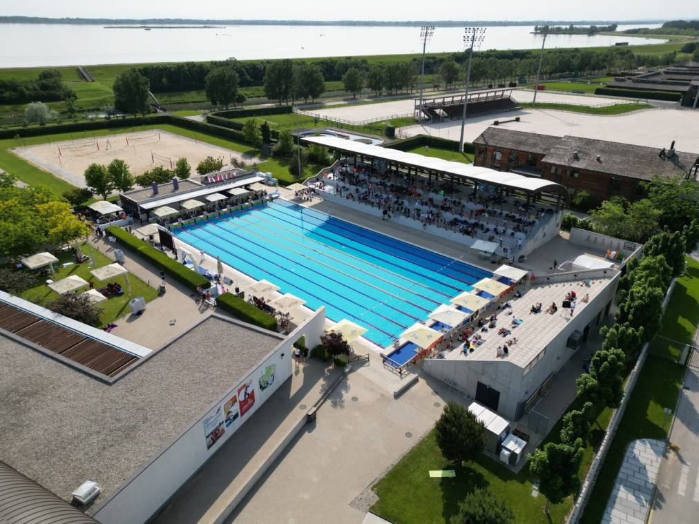 Outdoor 50m pool with full grandstand, aerial view