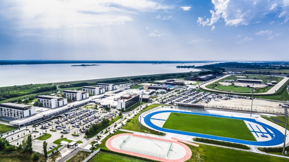 Lakefront resort overview with stadium, aerial view