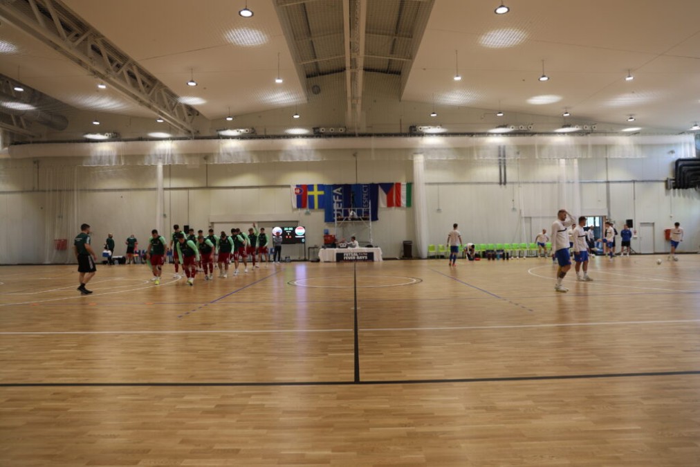 Indoor multi-purpose sports hall, teams warming up
