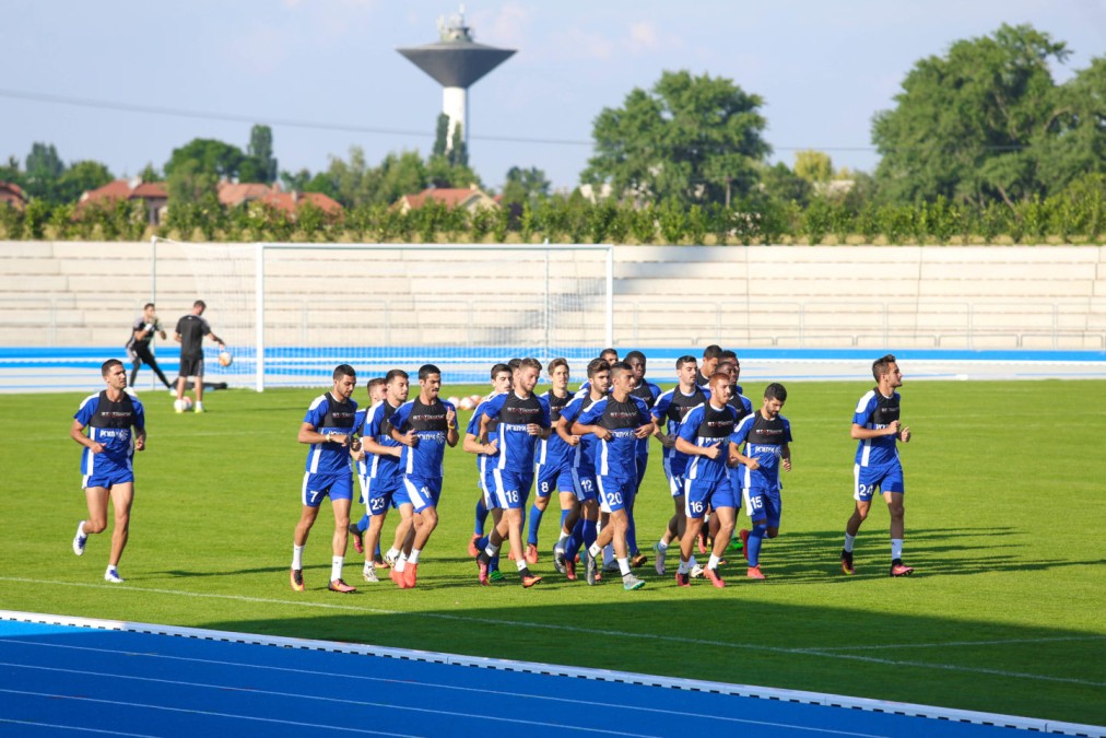 Football squad warm-up on the track infield