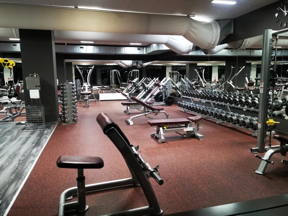 Gym floor with dumbbells and benches