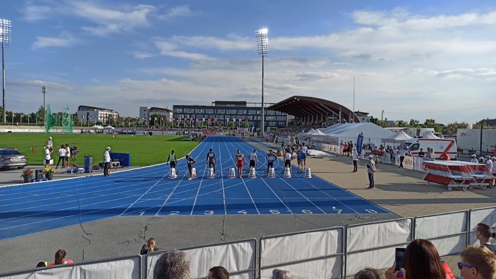 Athletics stadium — sprinters at the blocks