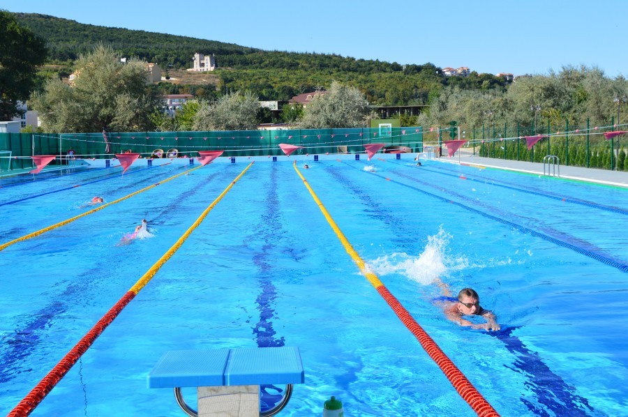 Outdoor 50m pool with swimmers training