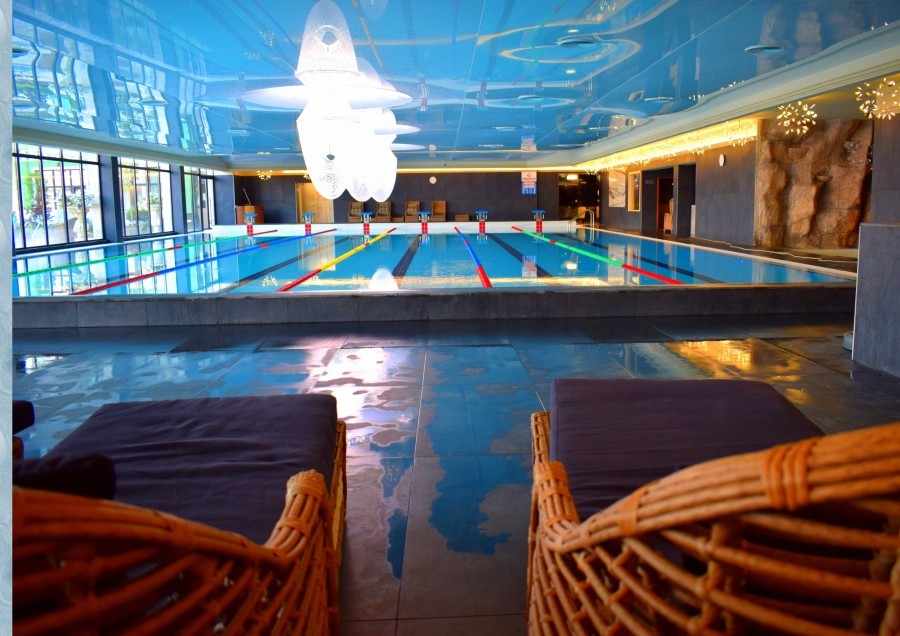 Indoor pool lounge with wicker seating