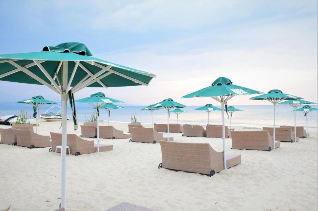 Private beach with loungers and umbrellas
