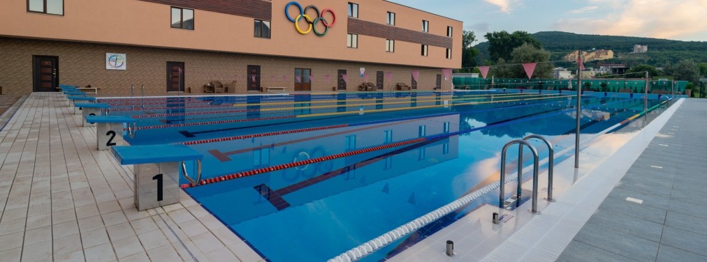 Outdoor pool at dusk with starting blocks