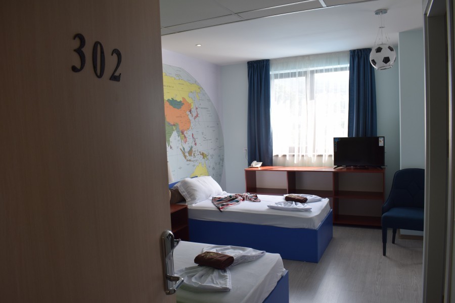 Themed kids' room with world map mural