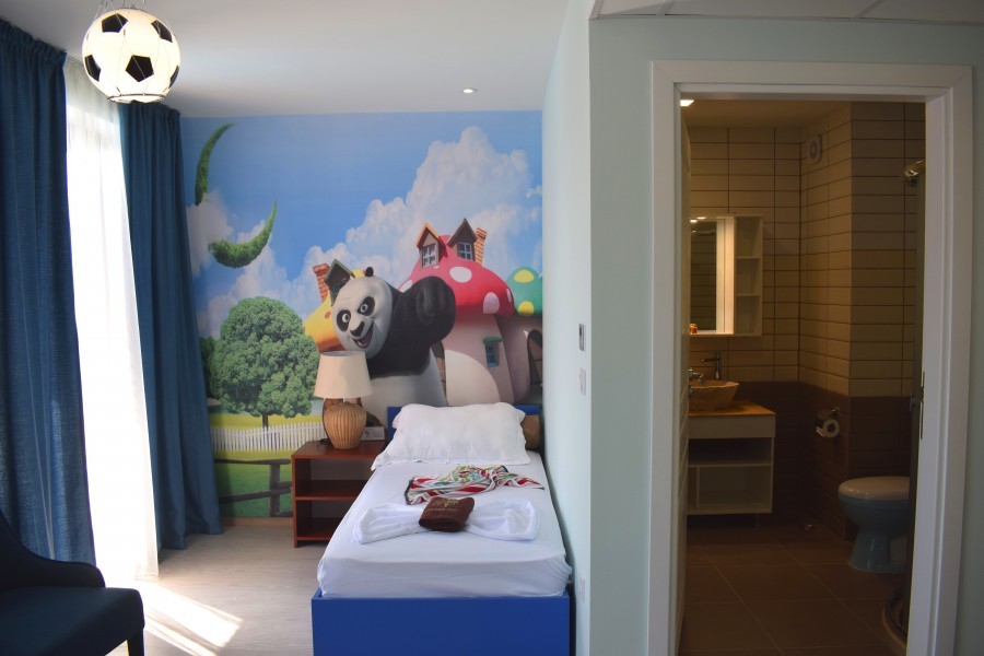 Themed kids' room with cartoon mural