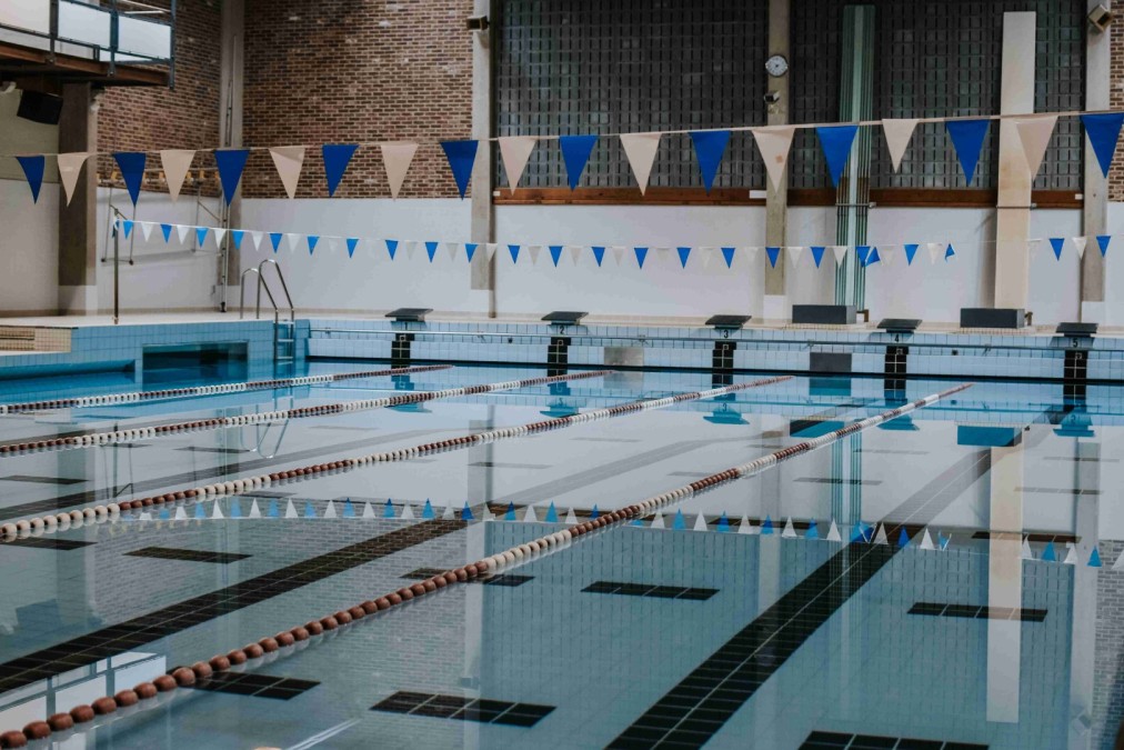 Indoor 25m pool with lane ropes and pennants