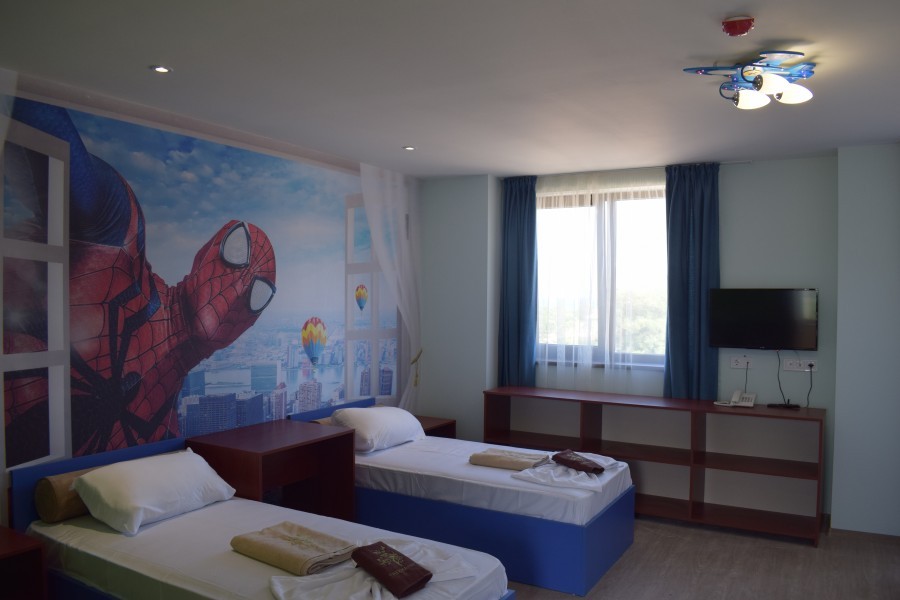 Themed kids' room with superhero mural