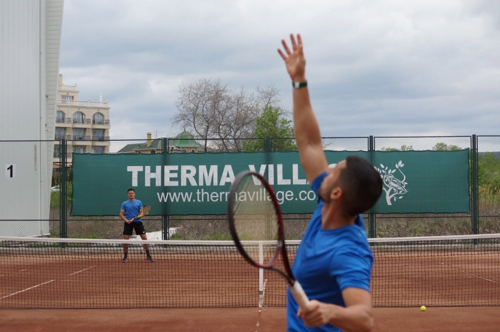 Clay court tennis match in progress