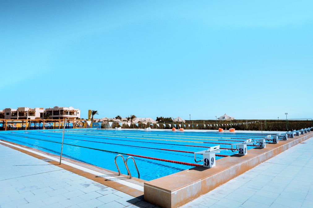 50m outdoor pool — starting blocks and lane markers, ground-level view