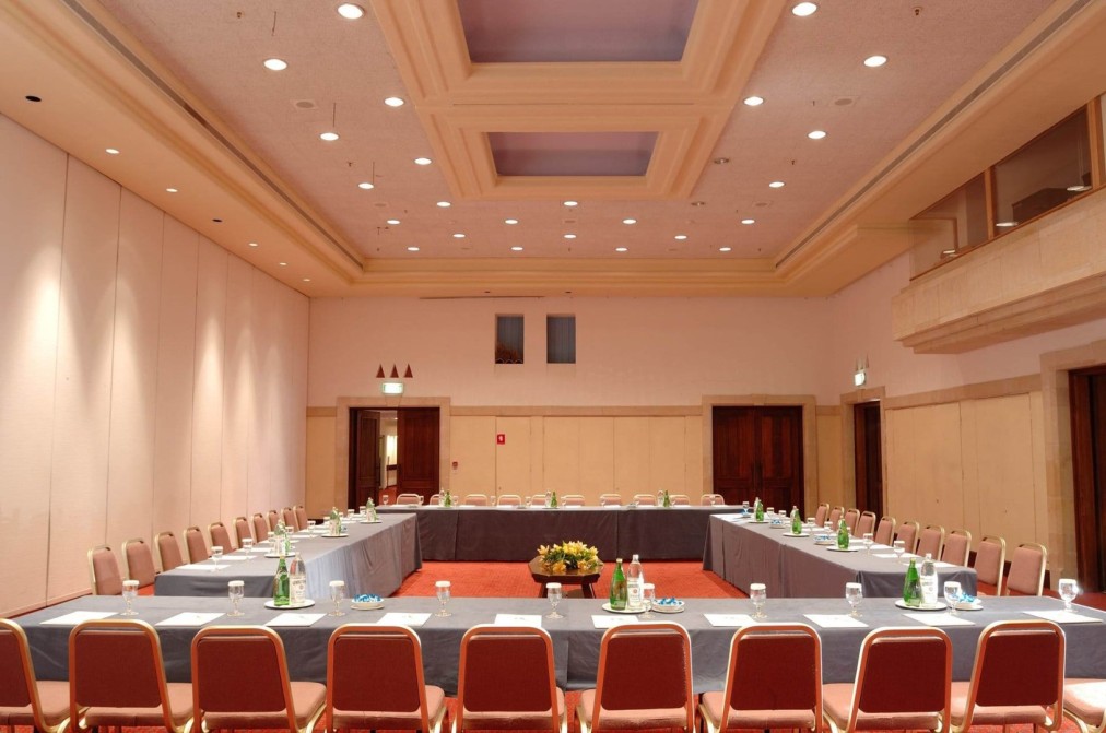 Spacious conference room with U-shaped seating and tables prepared for training camp meetings