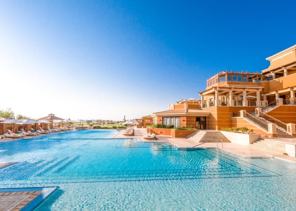 Large outdoor resort pool beside the main building, ideal for cooldown swims and leisure time