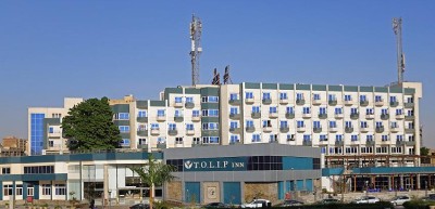 Exterior view of the Tolip Inn building with multiple balconies and entrance signage.