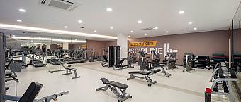 Weight room with benches, dumbbells and training equipment for conditioning sessions.