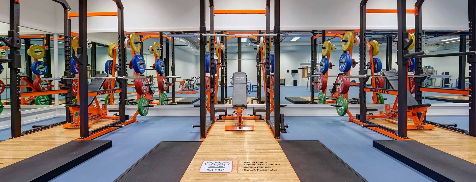 Strength training room with racks and plates