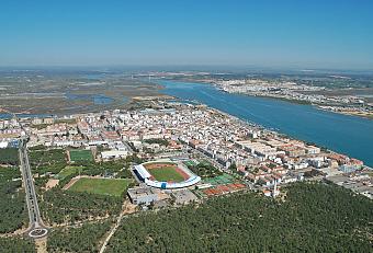 Aerial view of the sports complex beside the river and town.