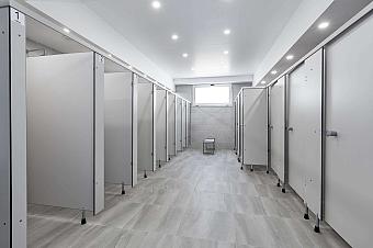 Shower and toilet area with multiple stalls in training facility