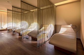 Relaxation lounge with cushioned recliners and soft lighting, used by athletes between practice sessions