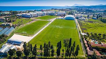 Seaside training grounds with two full-size football pitches and the sports complex nearby.