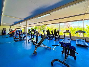 Fitness center with treadmills, bikes, and strength equipment for training camp workouts.