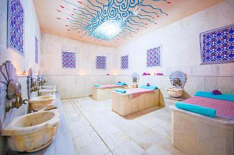 Hammam-style room with marble basins and heated massage platforms.