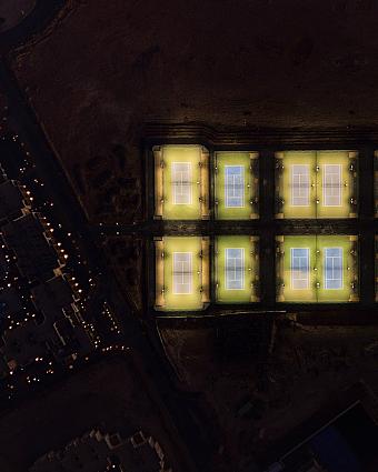 Aerial night view of eight illuminated tennis courts for training
