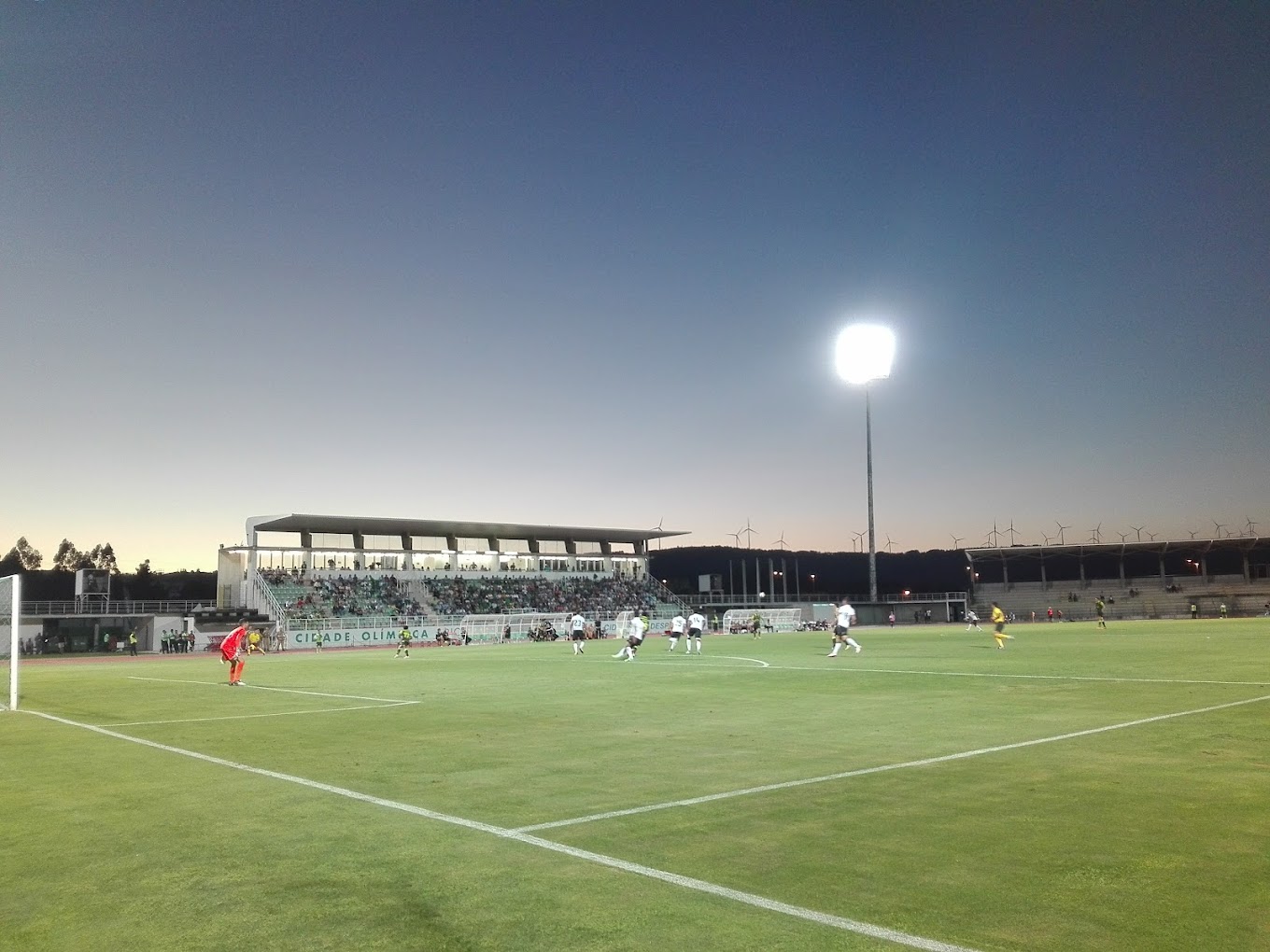 Floodlit stadium during evening match