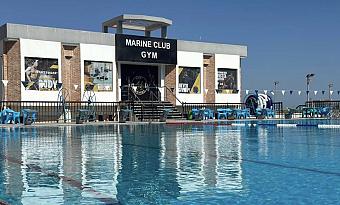 Close-up of Marine Club Gym building overlooking outdoor swimming pool