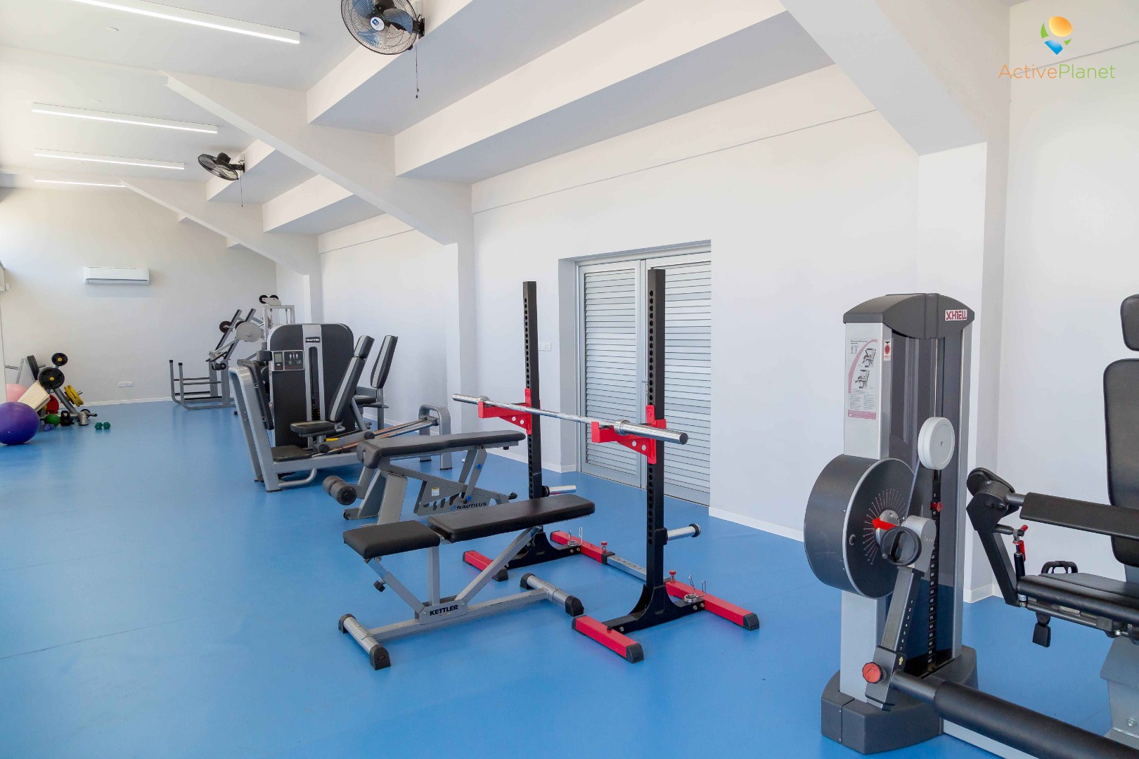 Modern gym with strength and cardio machines for athlete workouts
