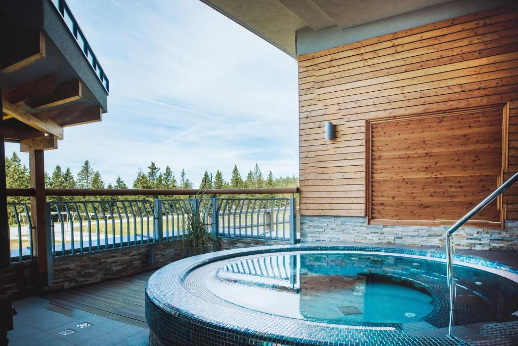 Outdoor whirlpool on a terrace overlooking the sports field.