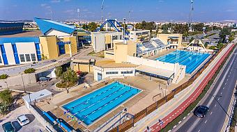 Aerial view of pools, grandstand and adjacent sports buildings.