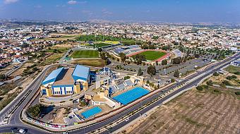 Aerial overview of pools, stadium and surrounding sports complex.