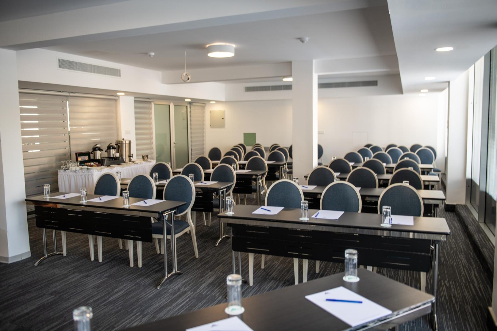 Conference room with classroom seating and coffee station
