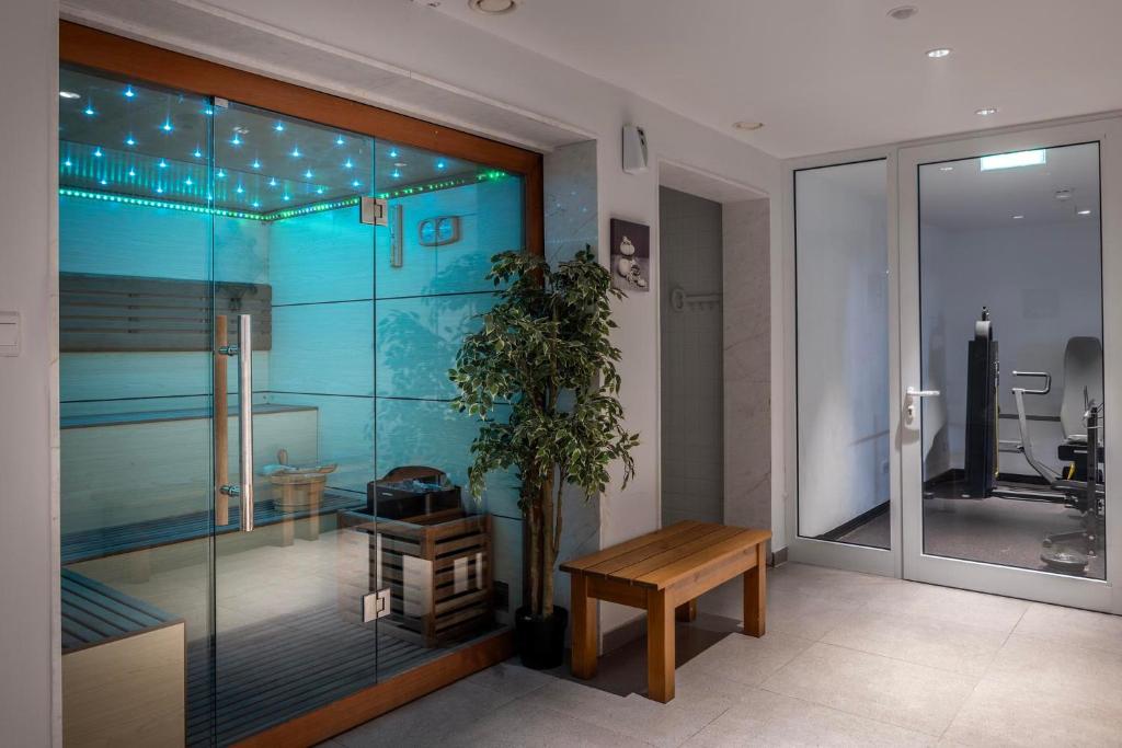 Sauna entrance with glass door and adjacent gym access