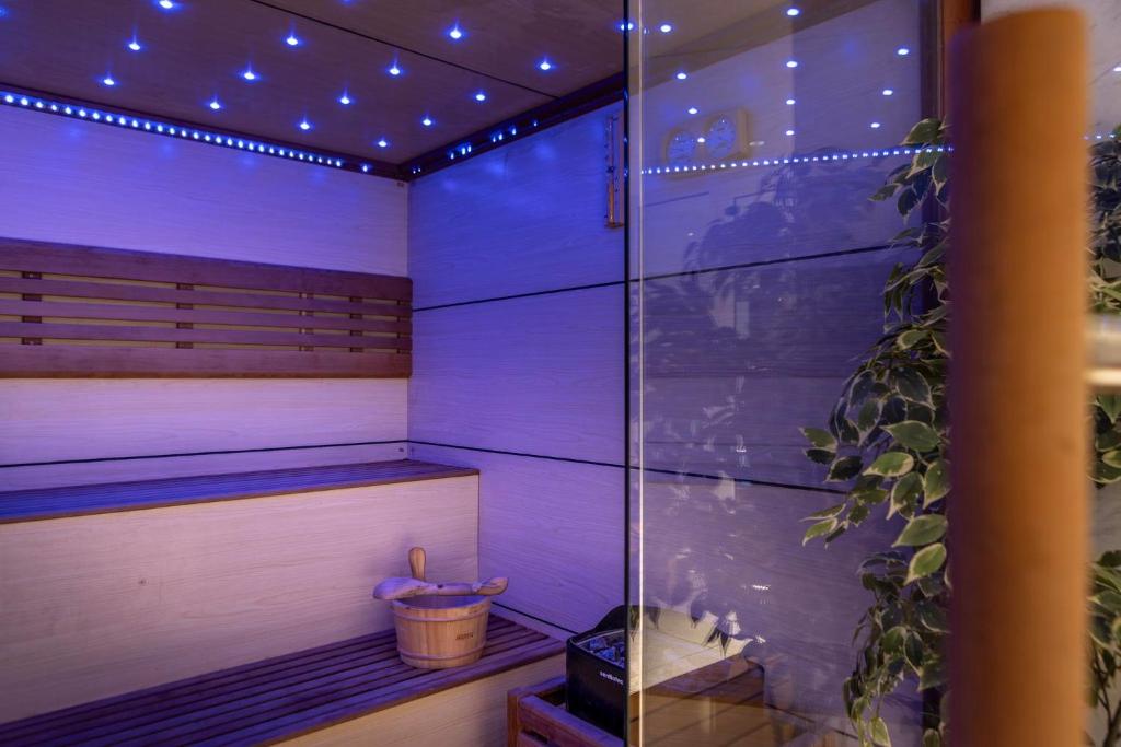 Finnish sauna interior with wooden benches and LED lighting