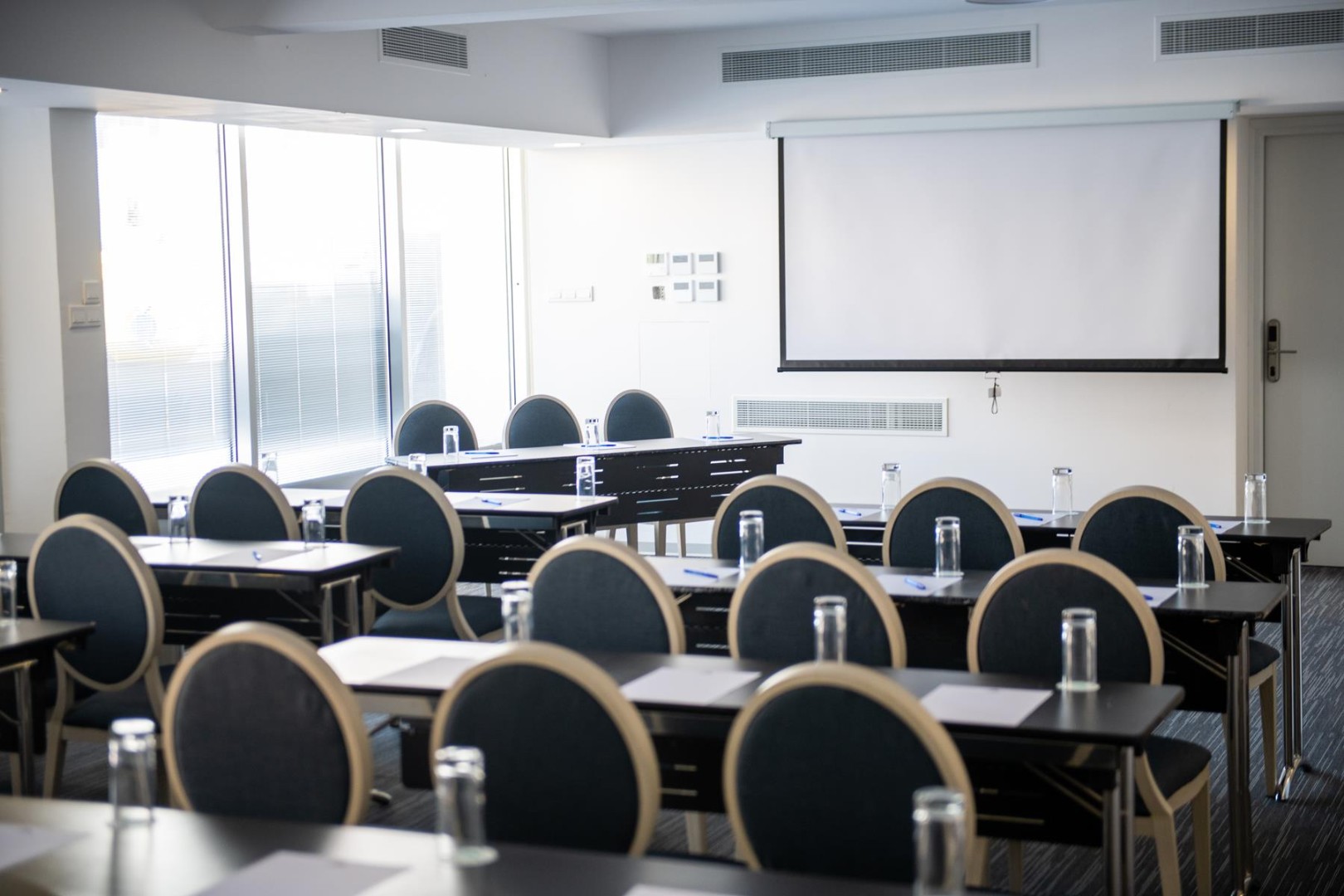 Conference room in classroom layout with projection screen