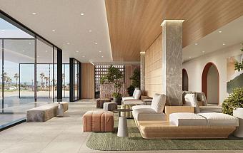 Lobby lounge with sofas, armchairs, and floor-to-ceiling windows