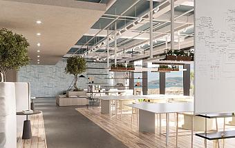 Open workspace with long tables, greenery, and large windows