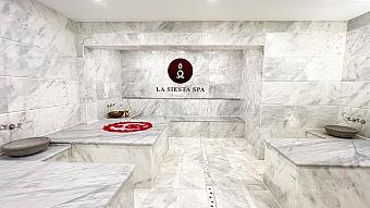 Luxurious marble spa interior with stone benches and “La Siesta Spa” sign on the wall