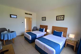 Comfortable twin room with blue accents, ideal for athlete accommodations during training camps
